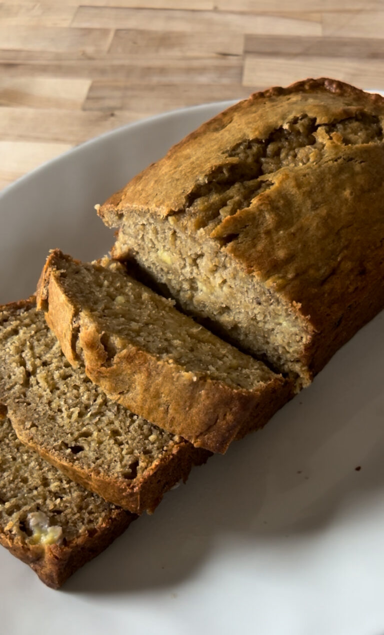 Plate of sliced sweet bread on a wooden table.